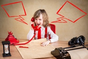 Shouting child businessman with retro phone. Success communication business concept